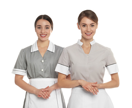 Portrait of chambermaids in tidy uniforms on white background