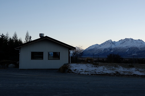 The warm house with snowy mountainous range during winter