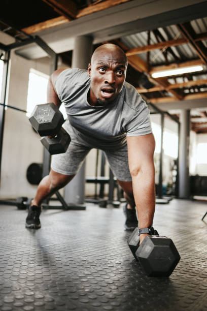 fitness, gym and black man doing a workout with weights for strength, wellness and training. bodybuilder, sports and strong african athlete doing push up exercise in a sport, health and active studio - askeri tatbikatı stok fotoğraflar ve resimler