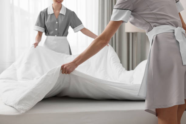 istock Professional chambermaids making bed in hotel room, closeup 1449354836