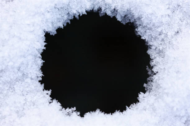 Close-up of icy snow texture makes round frame or border for abstract winter background stock photo