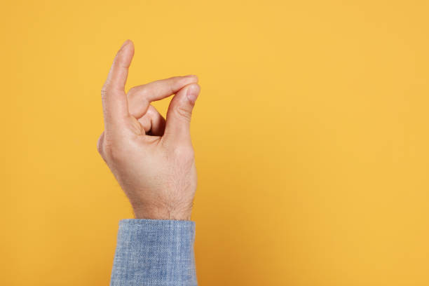 istock Man snapping fingers on yellow background, closeup of hand. Space for text 1449357455