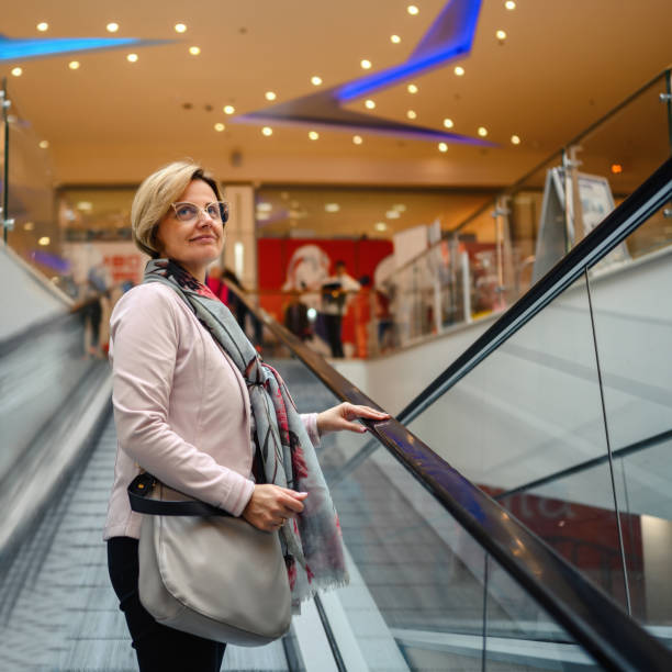 istock Woman On Escalator at Shopping Mall. 1449365012