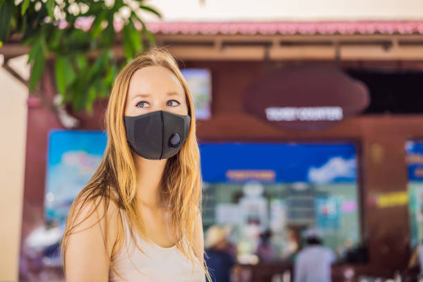 istock young woman wearing a hygiene protective mask over her face while walking at the crowded place. Healthcare and sickness prevention from coronavirus, Covid19 influenza in crowded place 1449365766