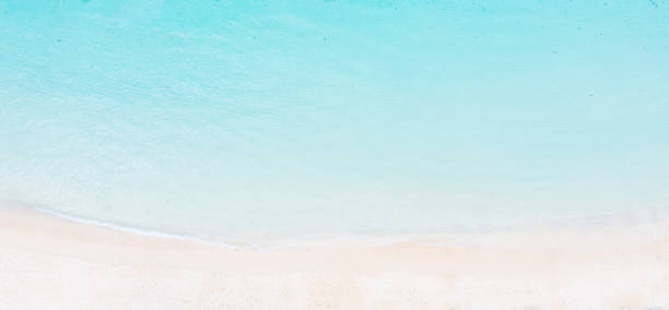 Panoramic beach scene from above - turquoise clean ocean and a clean sandy beach.