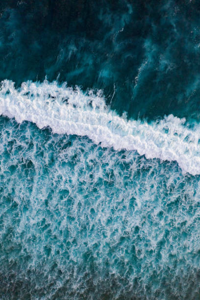 istock Big ocean waves hitting a coral reef. View from above. 1449370926