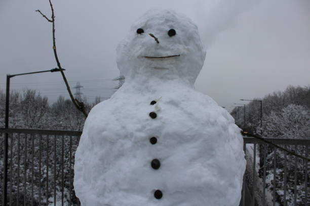 istock Snowman on the  snowy bridge 1449374236
