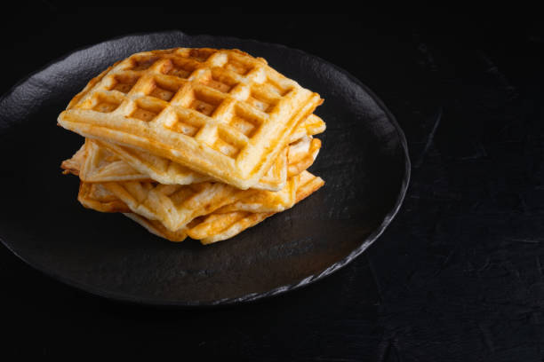 istock Belgian waffles on a black background. 1449374269