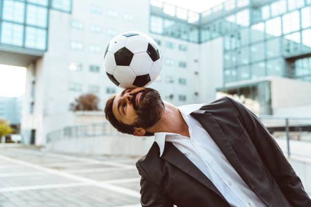 istock Businessman playing with a soccer ball and making freestyle tricks 1449377984