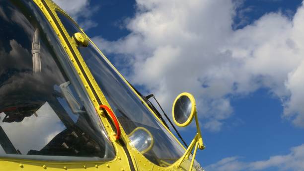 Round rear-view mirrors at yellow air transport. The rearview mirrors of bright yellow helicopter with blue azure cloudy skies in background. Camera moves to side, showing side mirrors of helicopter. espejos retrovisores redondos en el transporte aéreo amarillo. los espejos retrovisores de un helicóptero amarillo brillante con cielos nublados azules en el fondo. la cámara se mueve hacia un lado, mostrando los espejos laterales del helicóptero.