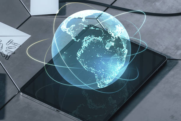 istock Close up of tablet on desktop with creative glowing globe hologram on blurry background. Technology, metaverse and digital map concept. Double exposure. 1449378096