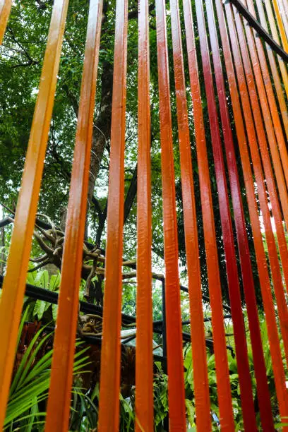 Photo of Decoration of a garden, a vertical fence with reddish-orange colors
