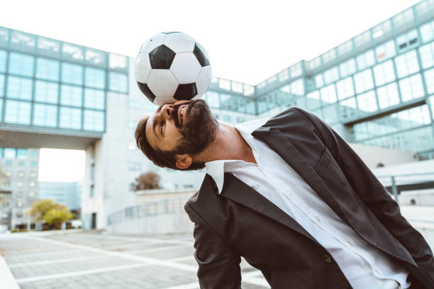 istock Businessman playing with a soccer ball and making freestyle tricks 1449378384