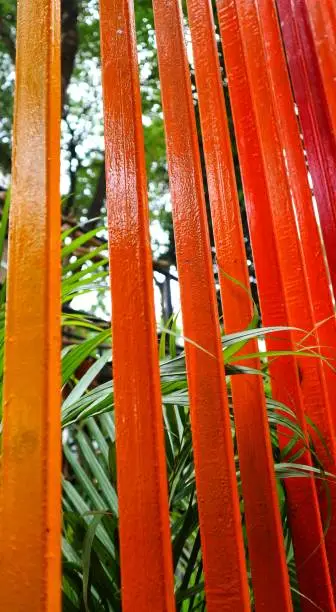 Photo of Decoration of a garden, a vertical fence with reddish-orange colors