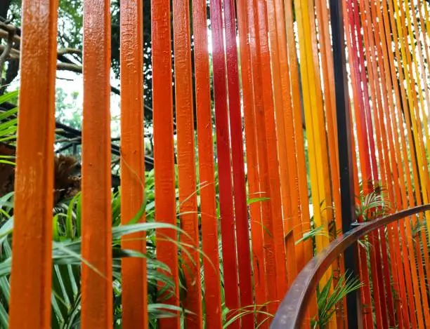 Photo of Decoration of a garden, a vertical fence with reddish-orange colors