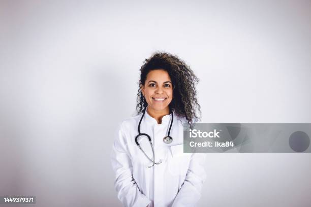 Latina Female Adult In A Studio Portrait Photo Stock Photo - Download Image Now - Coat - Garment, Doctor, Lab Coat