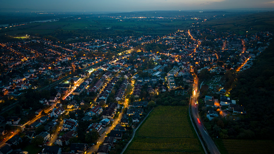 Aerial view over illuminated city at dusk - drone point of view