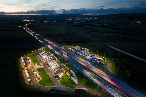 istock Highway and rest area at dusk - aerial view 1449380440