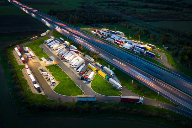 istock Highway and rest area at dusk - aerial view 1449380452