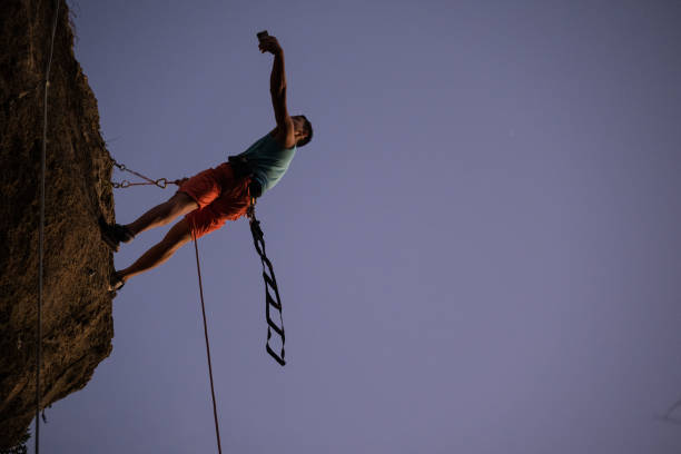 Climber taking selfie high up the wall