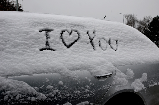 sign I love you on a parked snowy vehicle. one prank can mean divorce. All people suspect each other of infidelity. think about this before you sign the vehicle over to someone. prank, tag, joke