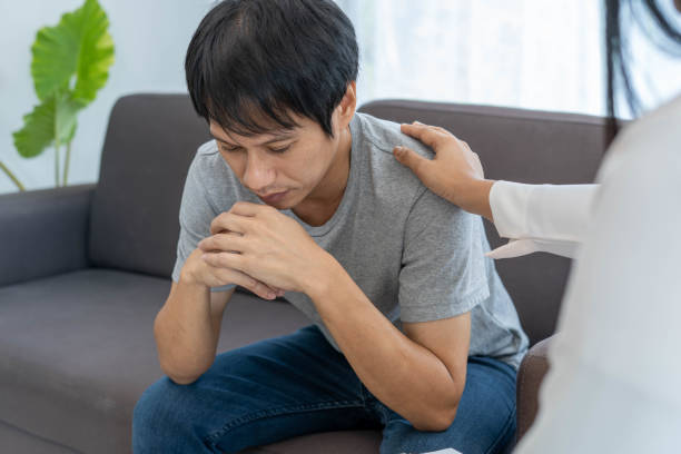 istock doctor man's hand touch shoulder to encourage a patient in distress or psychological problem. Concept of encouragement, mental health 1449381764