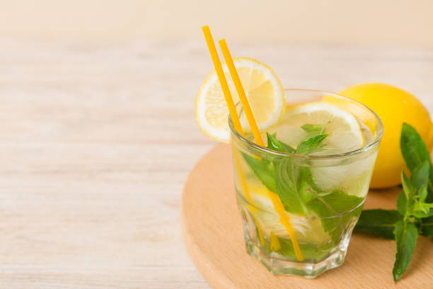 istock Mojito cocktail. Refreshing mojito cocktail with lime, lemon and mint in a tall glass with a stick 1449382871