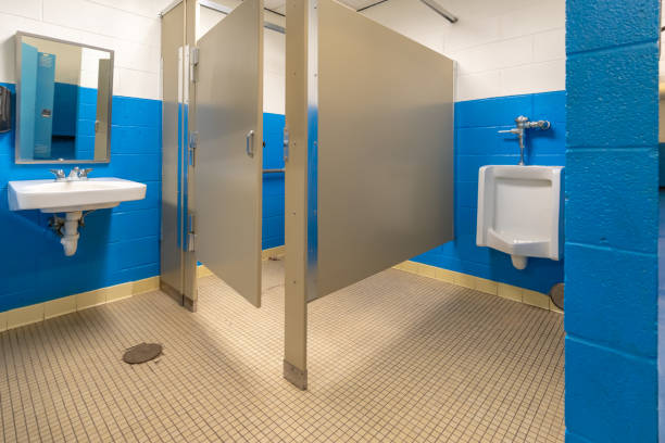 Nondescript bathroom plumbing with a white urinal in men's, boy's bathroom.