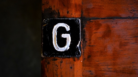 Just G alphabeth that stamped on a wooden table