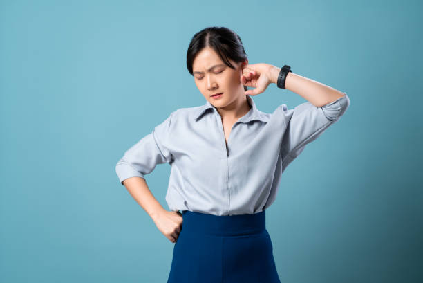 asian woman suffering from eyes pain standing isolated on blue background. - cotton swab audio imagens e fotografias de stock