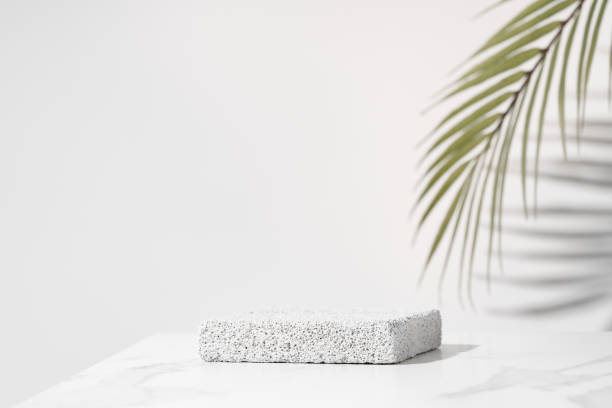 Porous pedestal on white table for beauty cosmetic product presentation. Bathroom shelf mockup. stock photo