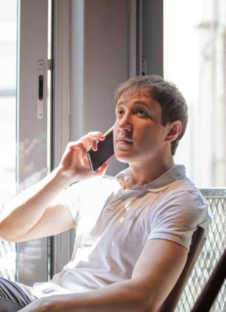istock Handsome guy is talking on the mobile phone. 1449386552