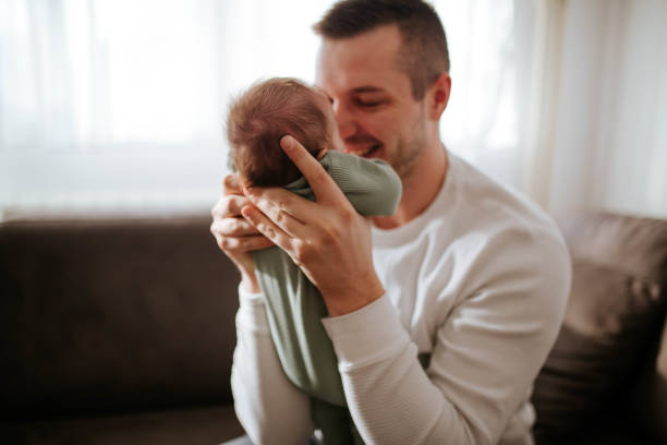 istock Young father holding his baby 1449388898