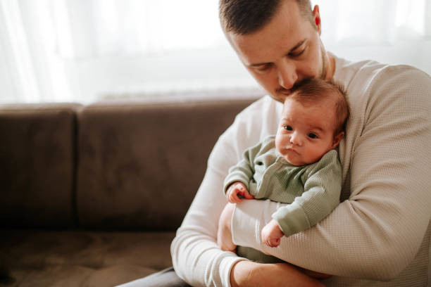 istock Young father holding his baby 1449388908