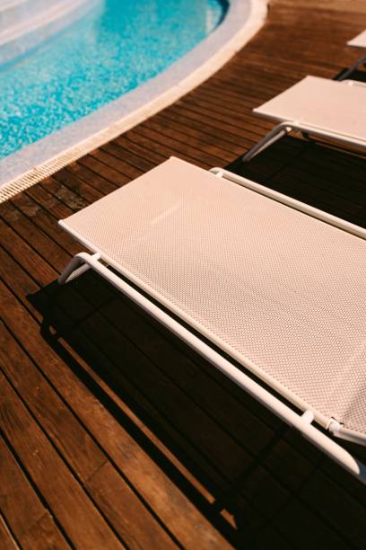 istock Vertical high-angle shot of folding chairs before a swimming pool 1449390407