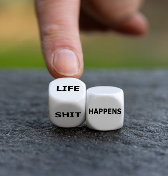 istock Hand turns dice and changes the expression 'shit happens' to 'life happens'. 1449391327