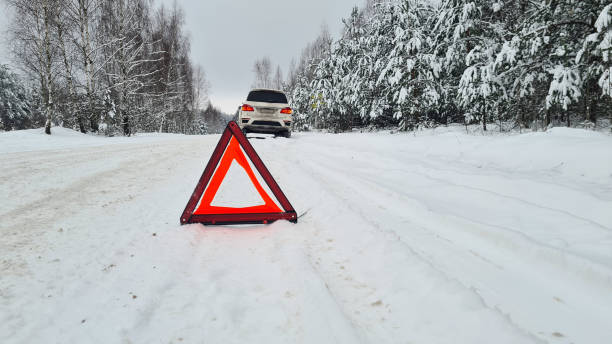 istock Auto winter and red warning triangle vehicle with broken car 1449392019
