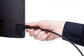 IT engineer Man hand inserts cable into monitor. Man hand connecting the DVI cable for monitor to computer PC. VGA DVI DisplayPort and power cable. close up in the hands of an . isolated
