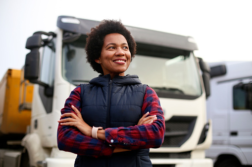 Mid adult female truck driver. About 40 years old, African woman.