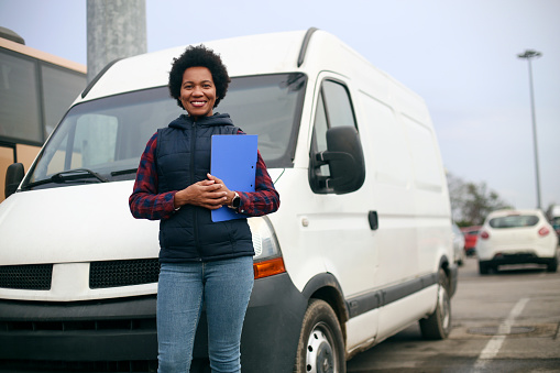 Mid adult female van driver. About 40 years old, African woman.