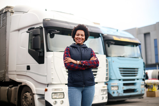 Mid adult female truck driver. About 40 years old, African woman.