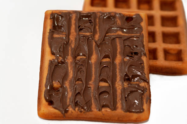 istock A waffle is a dish made from leavened batter or dough that is cooked between two plates that are patterned to give a characteristic size, shape, and surface impression, Belgian waffles isolated 1449397851