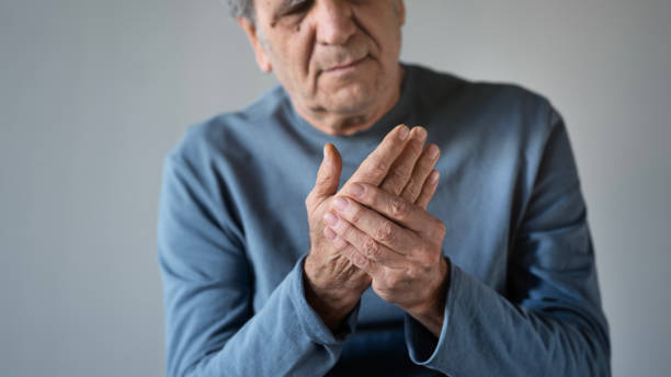istock Old man suffering from arthritis in his hand 1449398611