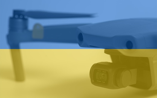 Double exposure of Flag of Ukraine and quadcopter drone aerial camera.