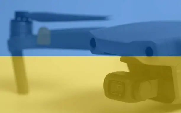 Photo of Double exposure of Flag of Ukraine and quadcopter drone aerial camera
