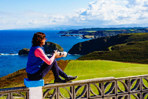 istock Tourist with camera on Asturias coast, Spain 1449401957