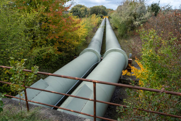 istock Thermal energy transfer infrastructure. central heating pipes in a protective metal thermal insulation jacket laid above the ground in europe. 1449403021