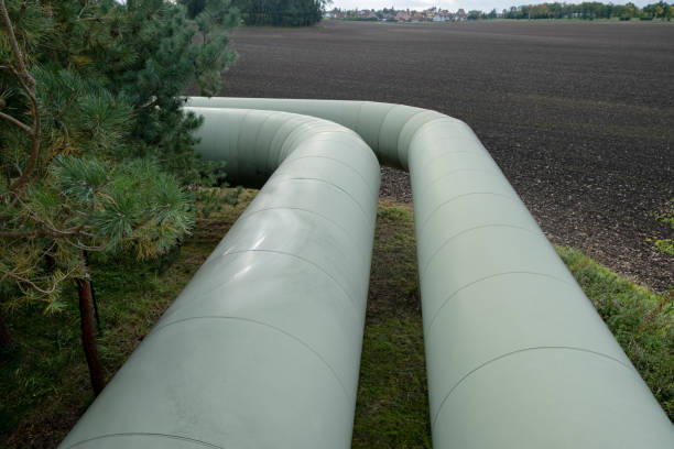 istock Thermal energy transfer infrastructure. central heating pipes in a protective metal thermal insulation jacket laid above the ground in europe. 1449403035