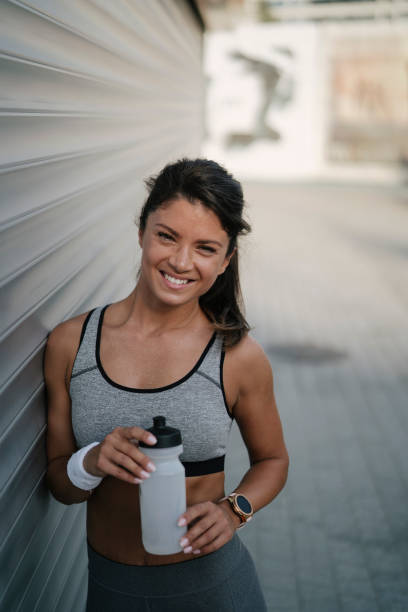 istock Young thirsty woman training outdoors 1449405245
