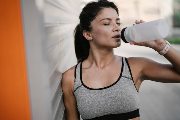 istock Young thirsty woman training outdoors 1449405292